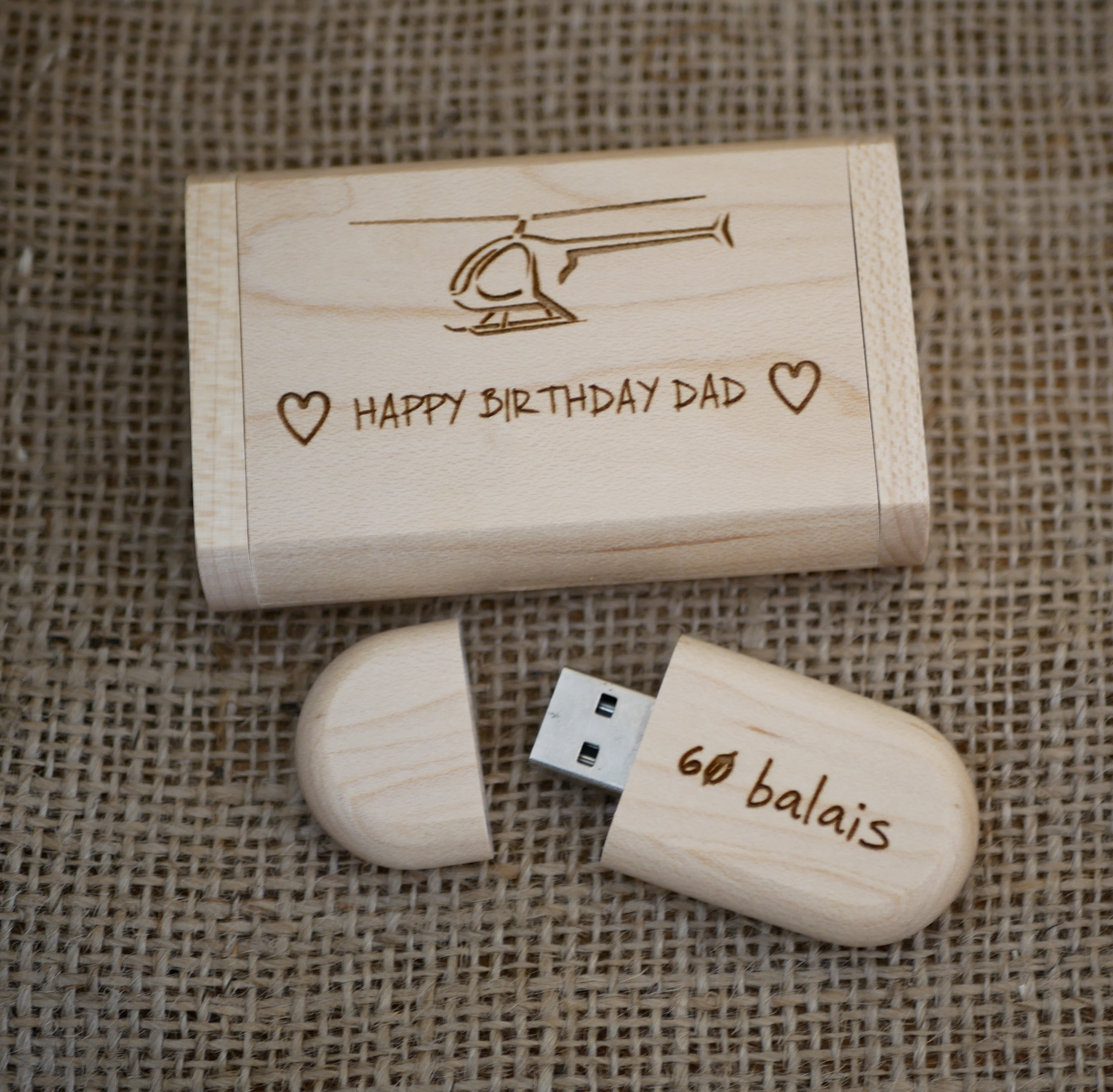 Engraving of a helicopter on a light wood USB key