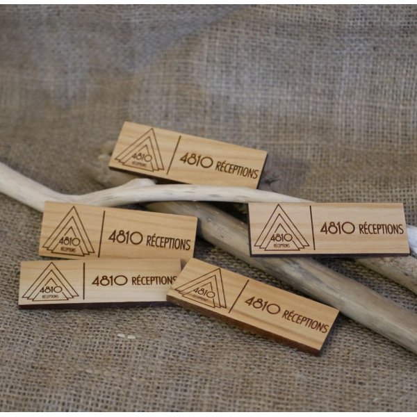 Wooden badge with company logo and name