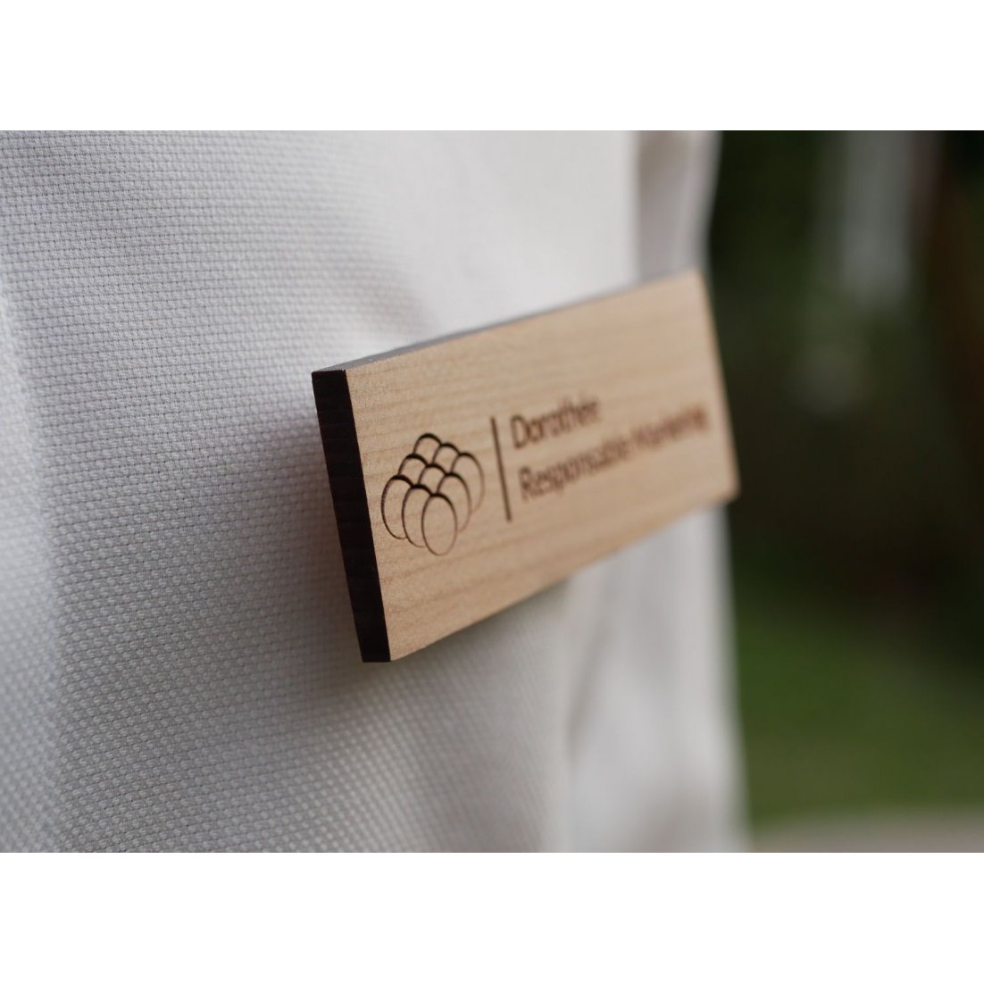 Wooden badge with company logo and name