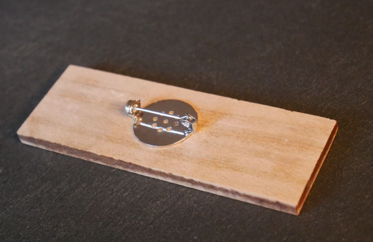 Wooden badge with company logo and name