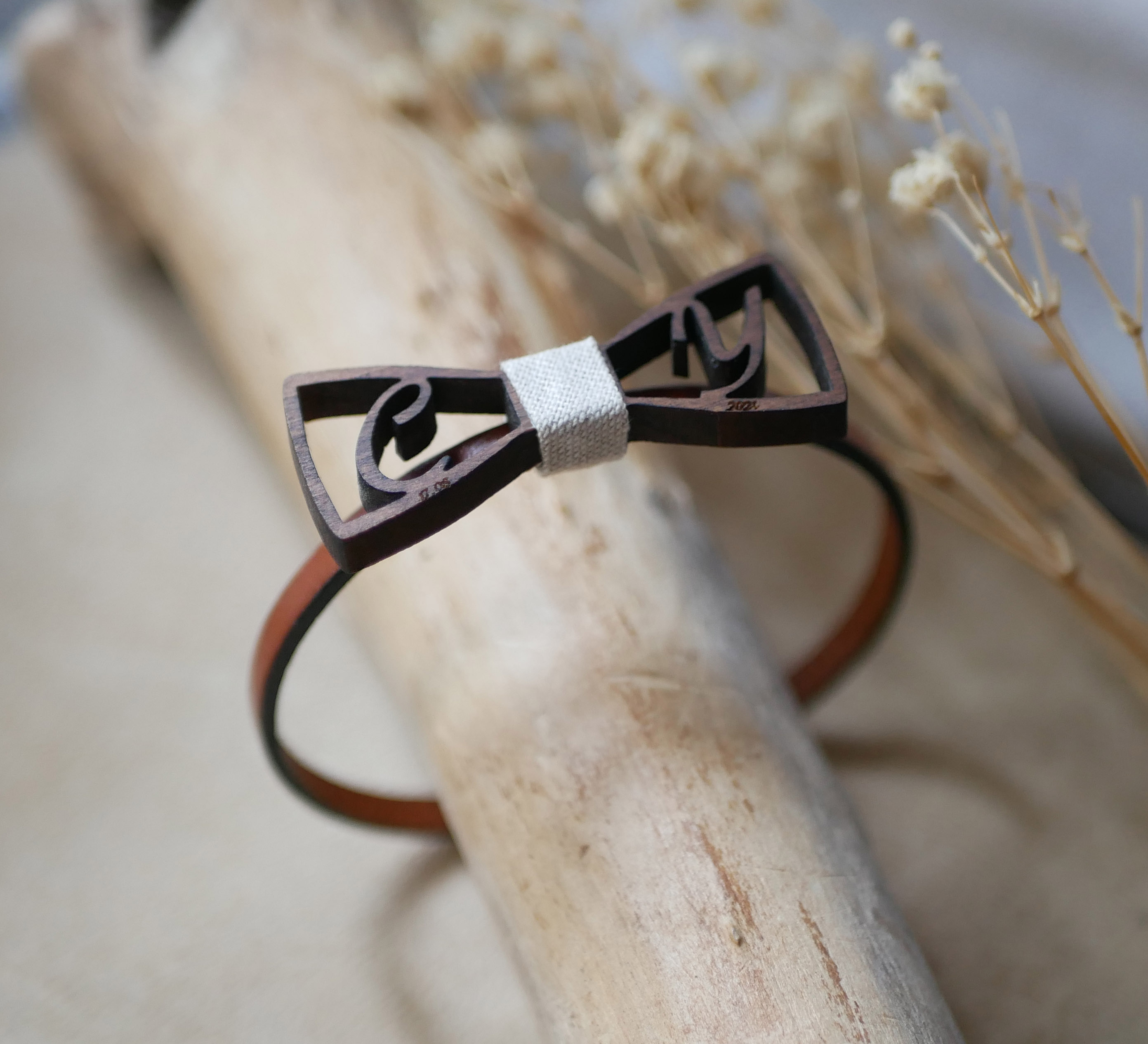 Leather bracelet with miniature wooden bow tie and openwork initials
