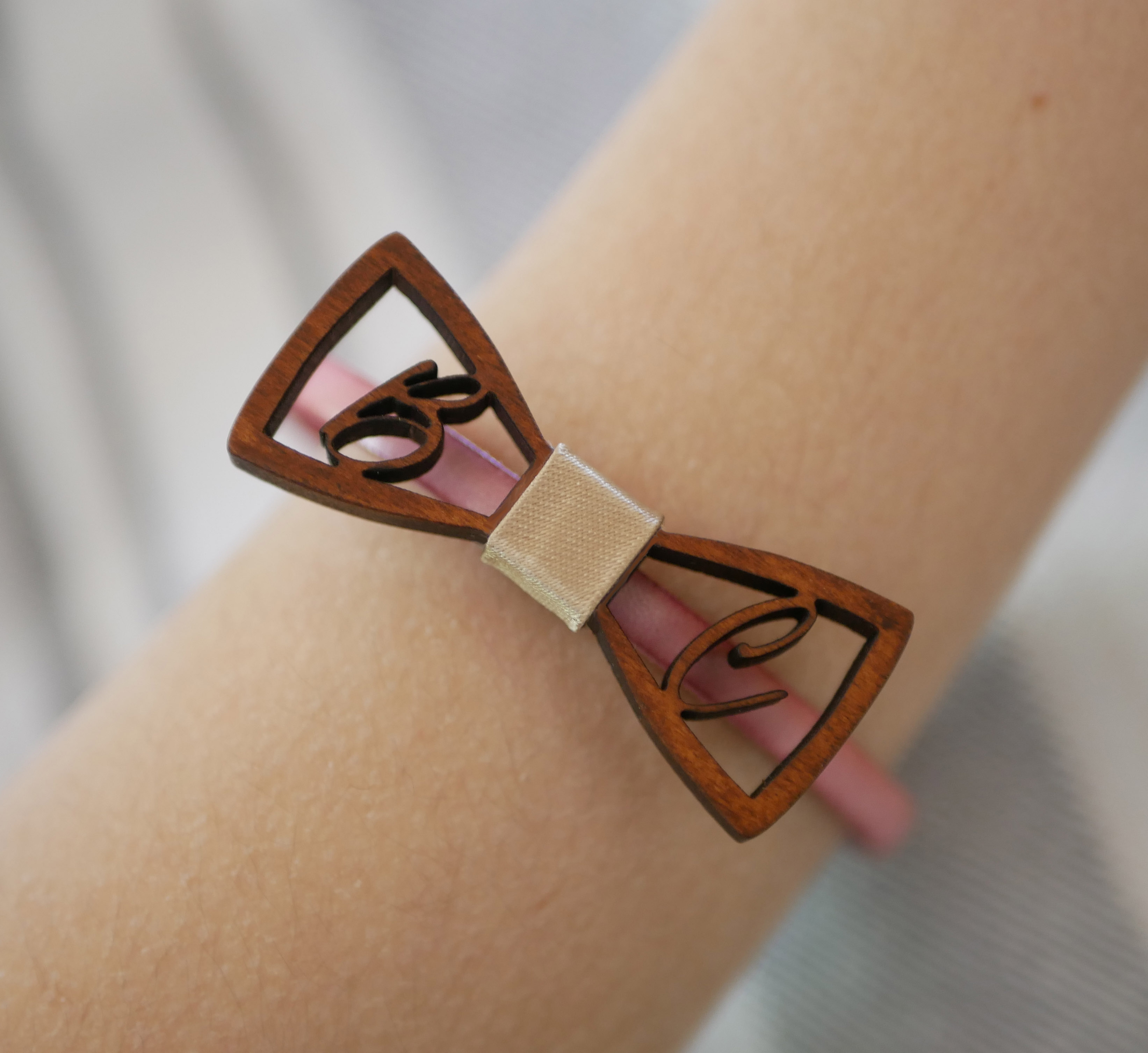 Leather bracelet with miniature wooden bow tie and openwork initials
